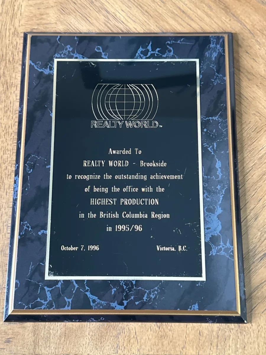 Realty World plaque awarded to Realty World – Brookside for the highest production office in the British Columbia Region in 1995/96, dated October 7, 1996, Victoria, B.C.