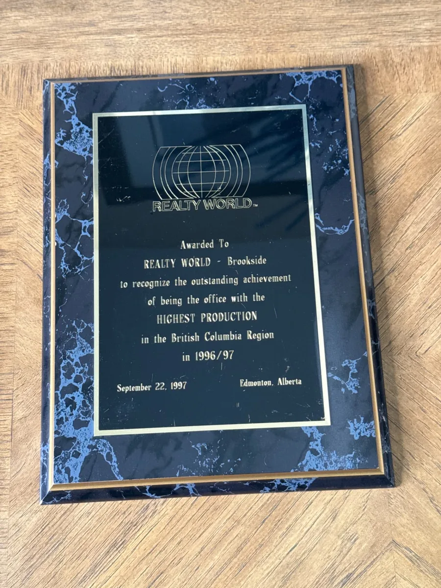 Realty World plaque awarded to Realty World – Brookside for the highest production office in the British Columbia Region in 1996/97, dated September 22, 1997, Edmonton, Alberta