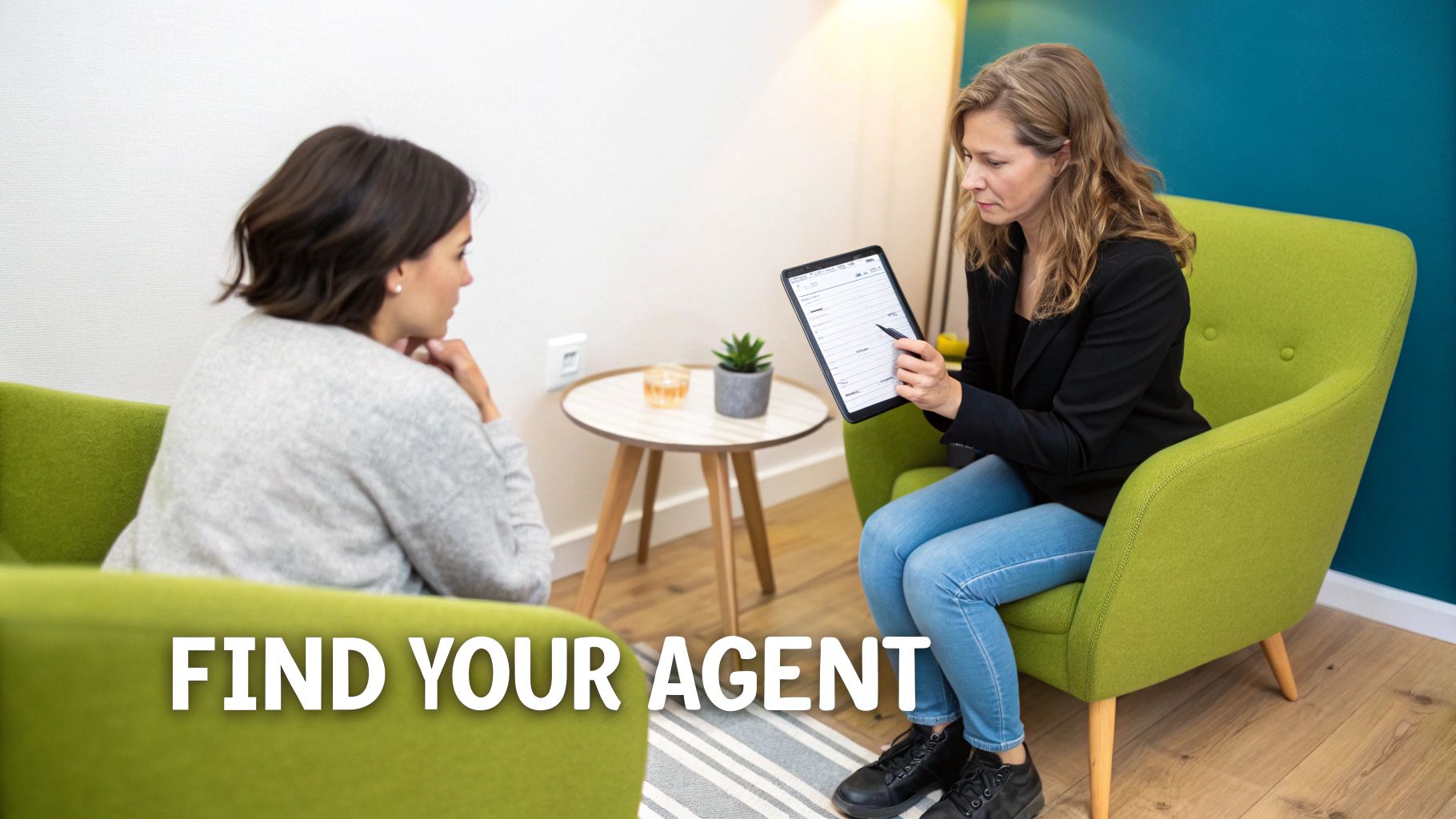 Two women, possibly a real estate agent and client, discuss a document on a tablet in a modern office.