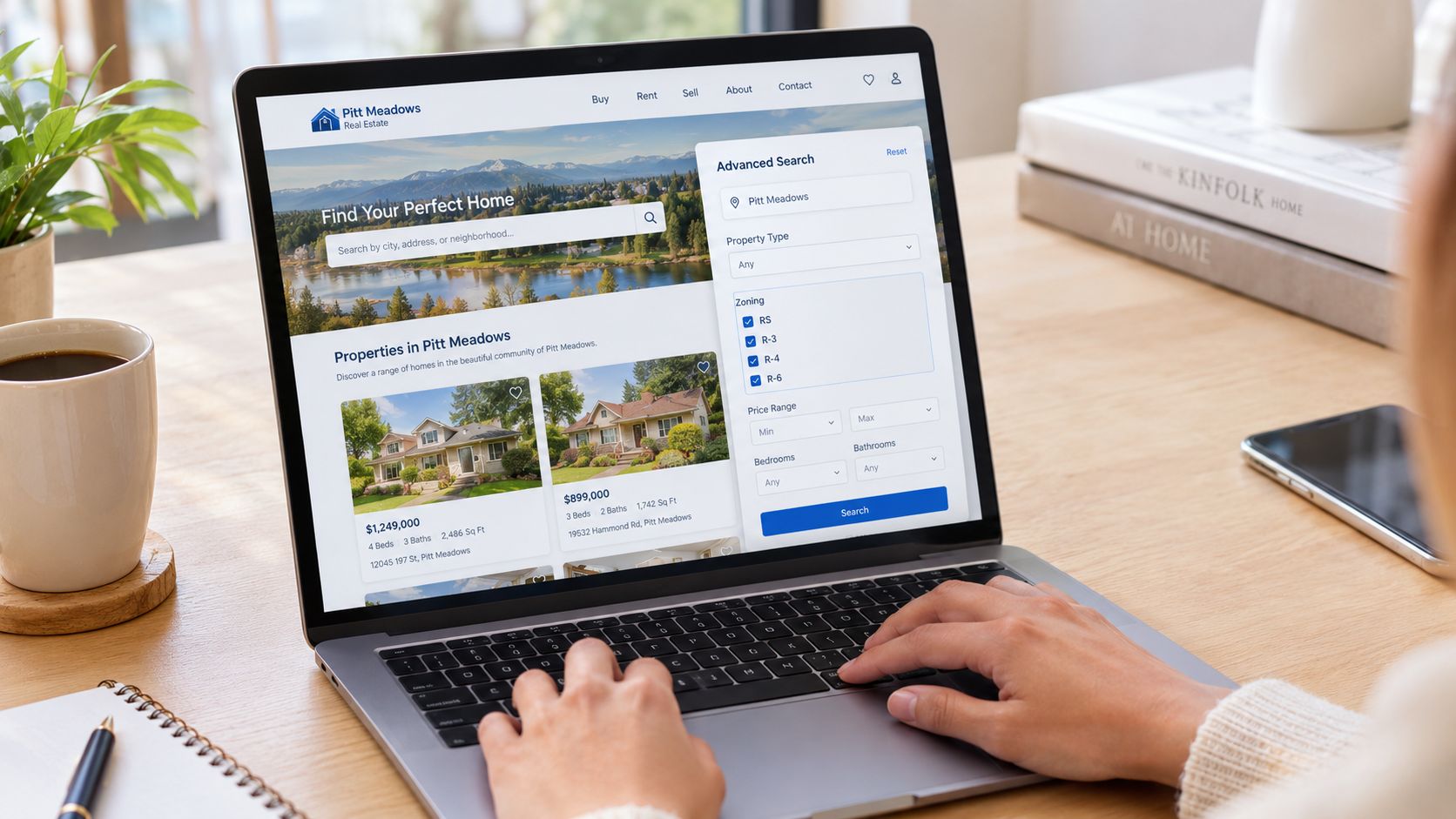 A person searching for houses for sale in Pitt Meadows on a laptop computer at a desk.