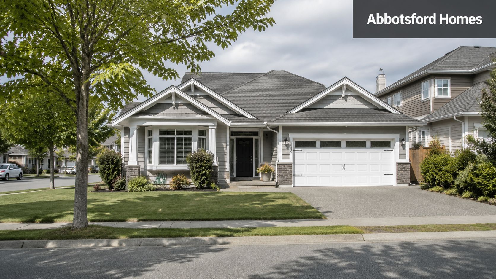 A modern grey single-story detached residential home with a white garage door and a green lawn.
