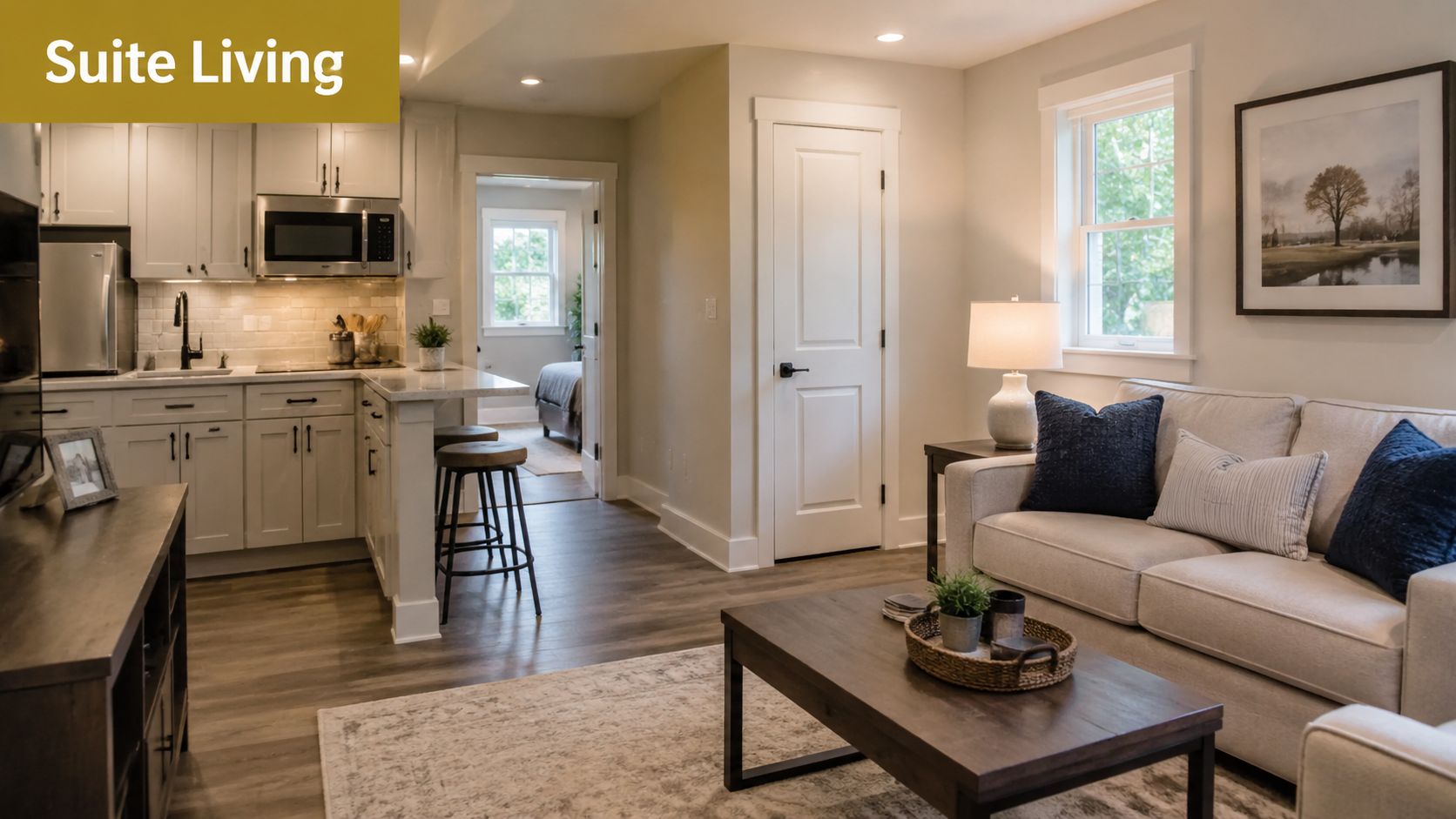 A modern and bright open-concept living area featuring a kitchen, breakfast bar, and comfortable cozy sofa.